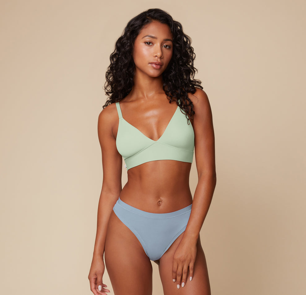 Full body view of Ally in the Bliss Triangle Bralette in Dew, paired with the Bliss Bikini in Glacier. The image highlights the bralette’s flexible fit and natural shaping.