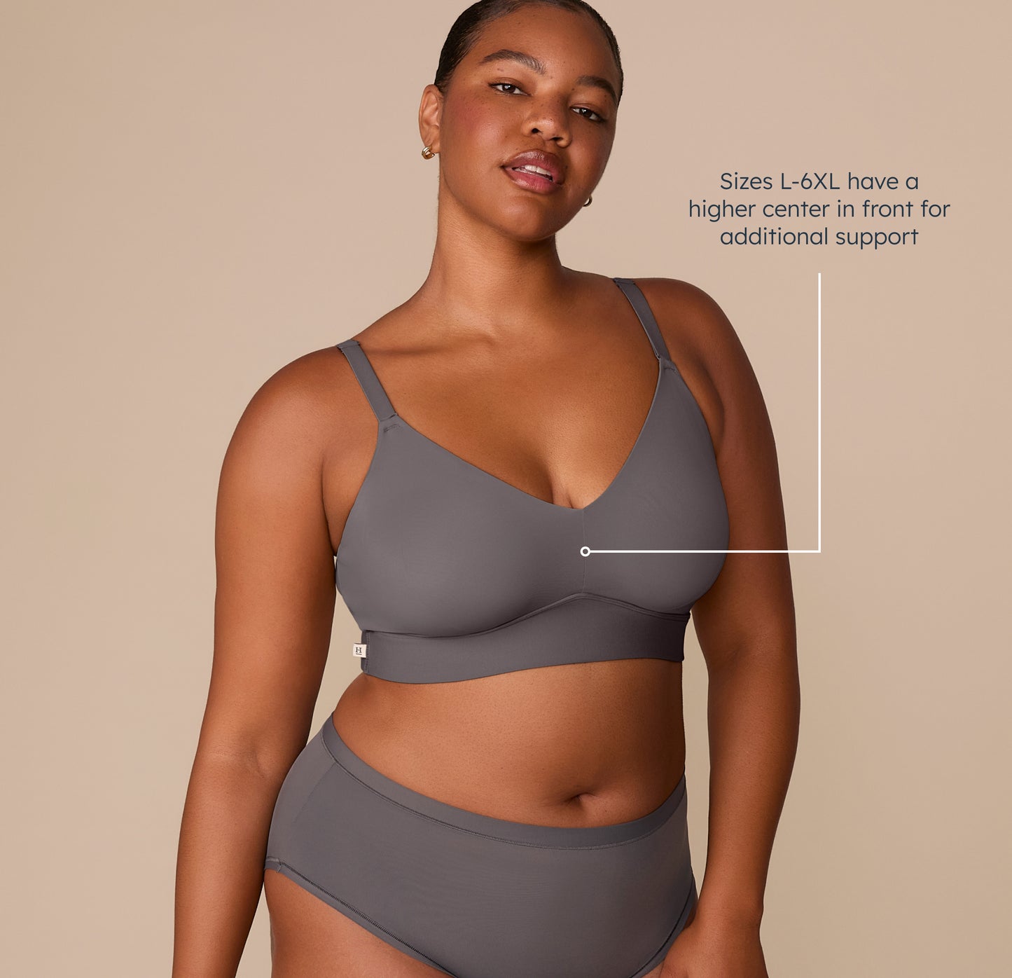 Zarria wearing the Bliss Triangle Bralette in Smoke. This image highlights the supportive design for sizes L–6XL, with a higher center front for added lift and support. sizing: Zarria wears size 2XL