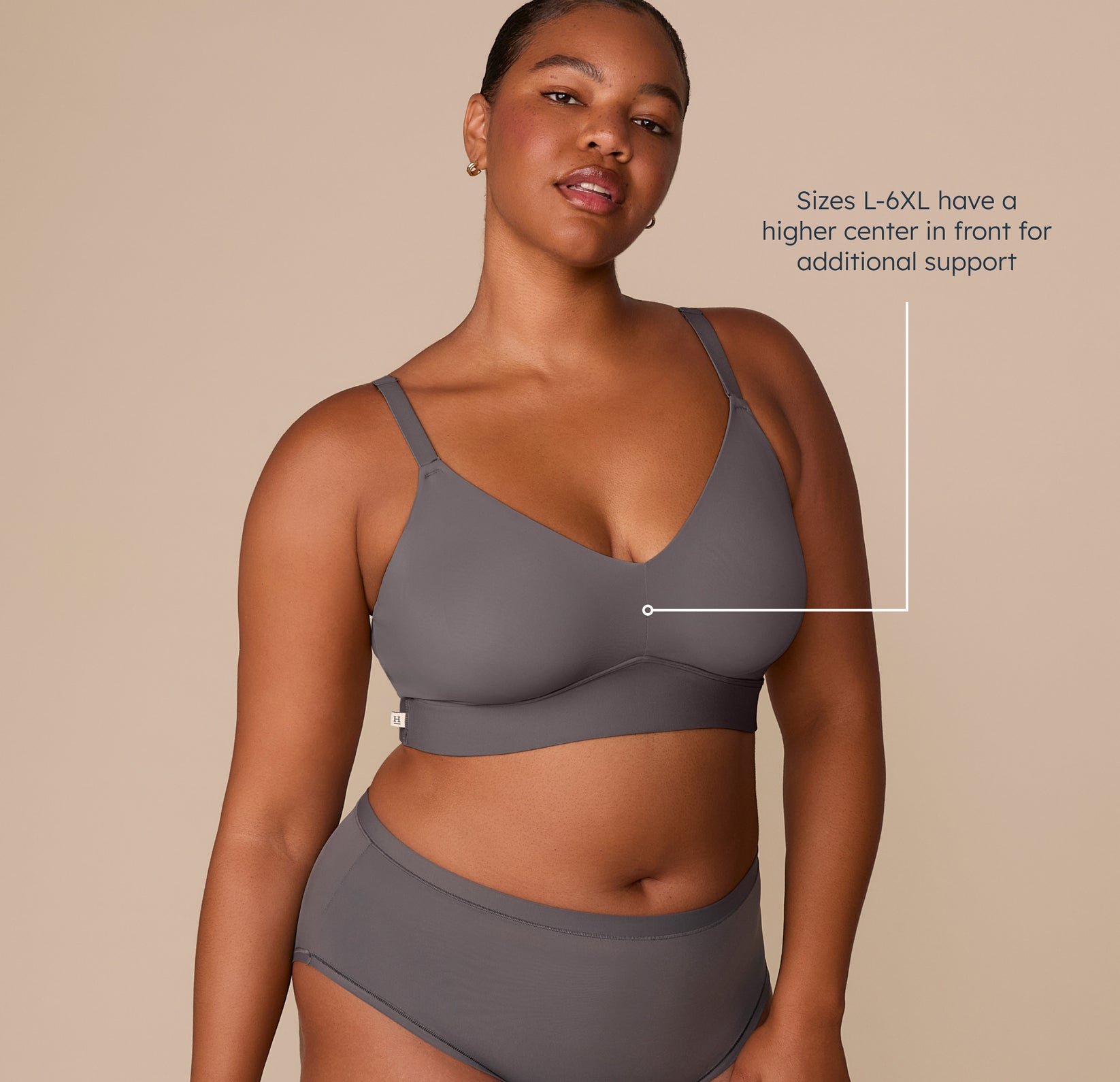 Zarria wearing the Bliss Triangle Bralette in Smoke. This image highlights the supportive design for sizes L–6XL, with a higher center front for added lift and support. sizing: Zarria wears size 2XL