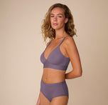 Freya models the Bliss Triangle Bralette in Eclipse and Bliss Highwaist Brief in Eclipse in a side pose. The view showcases the sleek fit, soft structure of the bralette, and the smoothing design of the highwaist brief.
