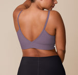 India turns away from the camera, displaying the back of the Bliss Triangle Bralette in Eclipse and the Bliss Boyshort in Black. The deep V-back and wide underband of the bralette are paired with the full-coverage, high-rise silhouette of the boyshort in Black.