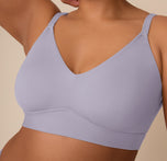 A close-up of Zarria wearing the Bliss Triangle Bralette in Violet, showing detailed features like the molded cups, smooth V-neckline, and supportive underband for a seamless, wire-free silhouette.