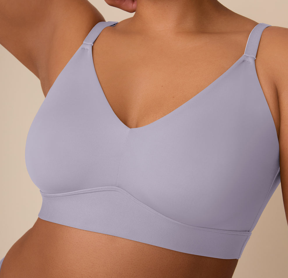 A close-up of Zarria wearing the Bliss Triangle Bralette in Violet, showing detailed features like the molded cups, smooth V-neckline, and supportive underband for a seamless, wire-free silhouette.