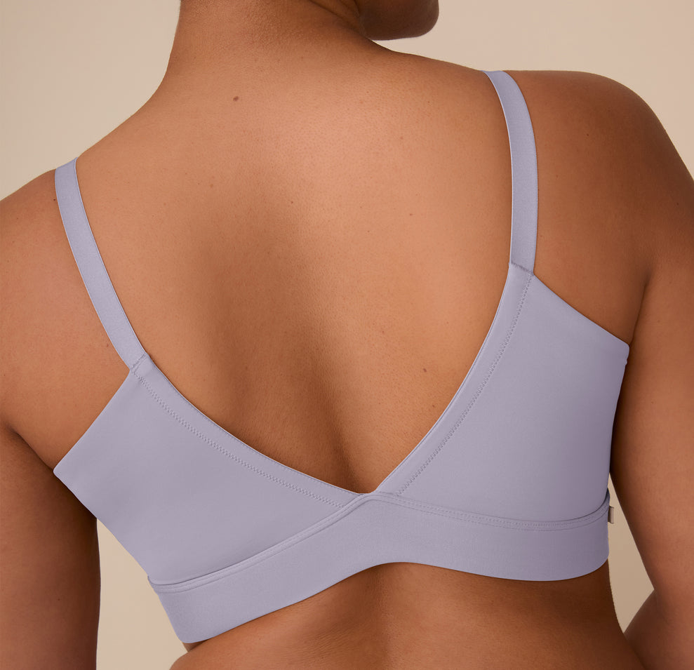A back close-up of the Bliss Triangle Bralette in Violet worn by Zarria, focusing on the deep V-back design, minimal seams, and soft Violet fabric that lays flat against the skin.