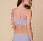 Gracie is shown from the back wearing the Bliss Triangle Bralette in Violet and the Bliss Hiphugger in Violet. The bralette’s supportive V-back and the hiphugger’s smooth, full-coverage fit are visible in the elegant Violet hue.