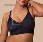 Close up shot of India in the Bliss Triangle in Black. The tagline reads "Sizes L-6XL have a higher center in front for additional support". sizing: India wears size Large