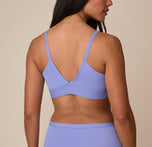 Back view of Nemesis wearing the Bliss Triangle Bralette in Dusk. The image shows the bralette’s deep V-back and front adjustable straps, emphasizing comfort and a sleek silhouette.