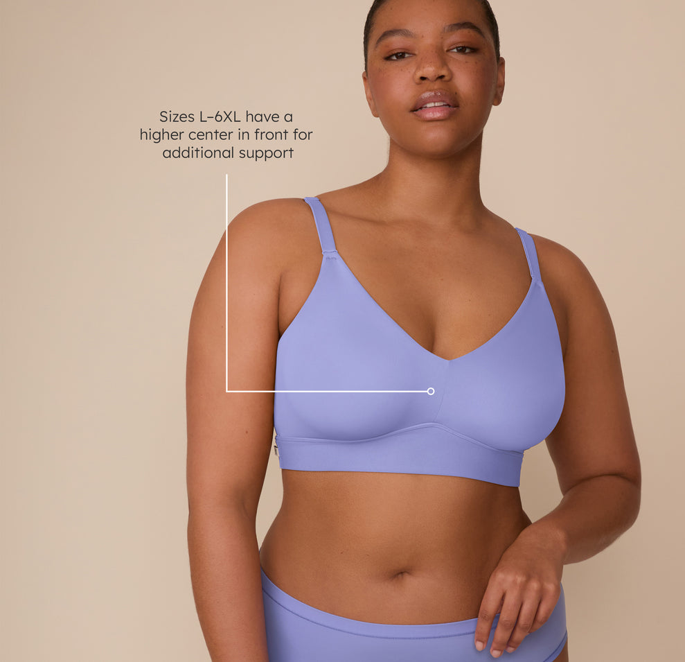 Zarria wearing the Bliss Triangle Bralette in Dusk, annotated with sizing detail. Text on the image notes that sizes L–6XL feature a higher center in front for added support. sizing: Zarria wears size 2XL