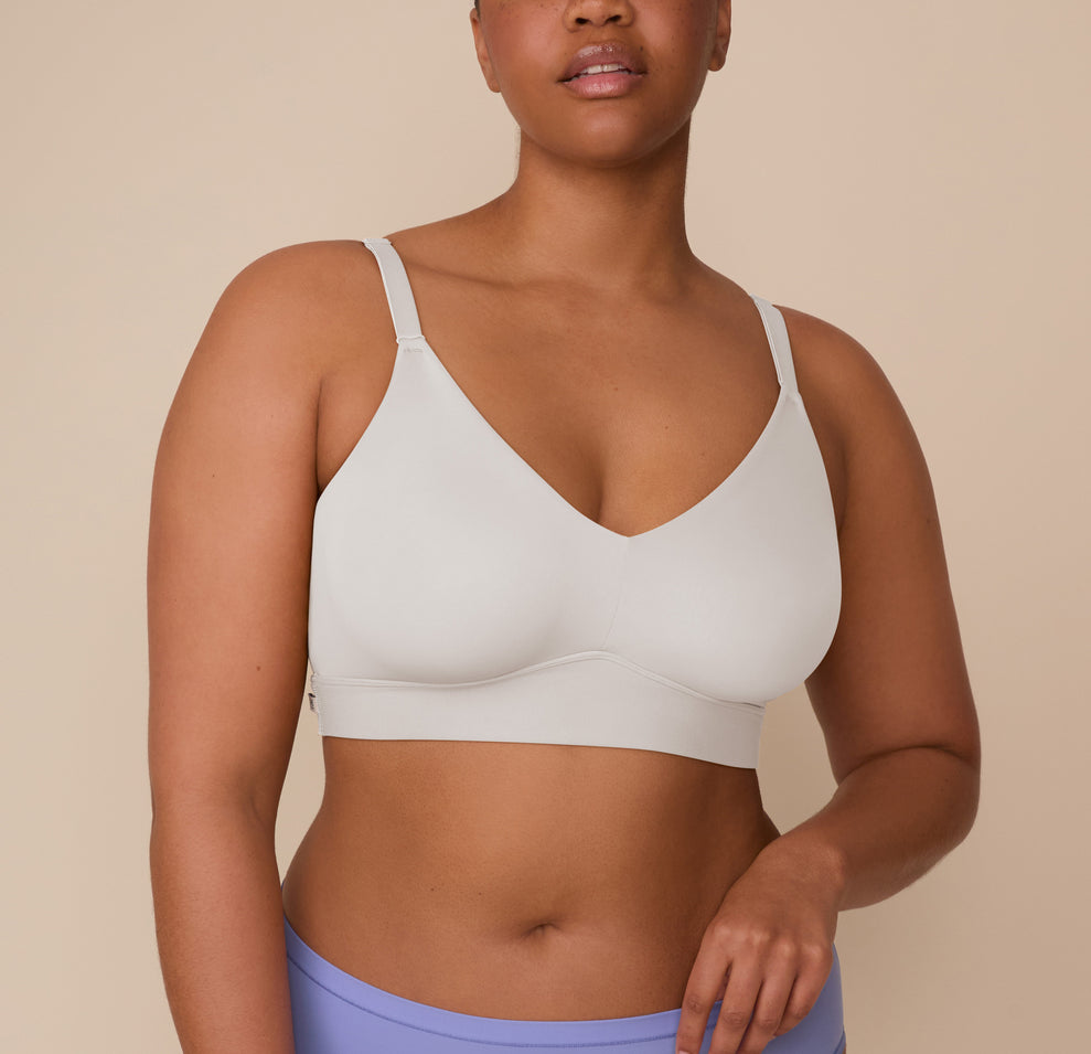 Close-up of Zarria wearing the Bliss Triangle Bralette in Frost. The image highlights the plunging neckline and ultra-smooth fabric of the bralette. sizing: Zarria wears size 2XL