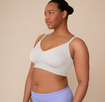 Three quarter angle of Zarria wearing the Bliss Triangle Bralette in Frost. Her pose showcases the soft contouring designed for natural shaping and support.