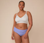 Full-body shot of Zarria wearing the Bliss Triangle Bralette in Frost and Bliss Hiphugger in Dusk. She stands with a relaxed pose, emphasizing the flattering, smooth fit of both pieces.