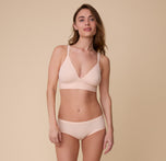 Gracie wears the Bliss Triangle Bralette in Rose with the matching Bliss Hiphugger. The set emphasizes a smooth, second-skin fit.