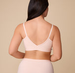 A rear view of Emersyn wearing the Bliss Triangle Bralette in Rose, highlighting the low-cut back and smooth, stretch fabric.