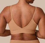 A close-up of the back of India wearing the Bliss Triangle Bralette, emphasizing the smooth, adjustable straps and flexible band.
