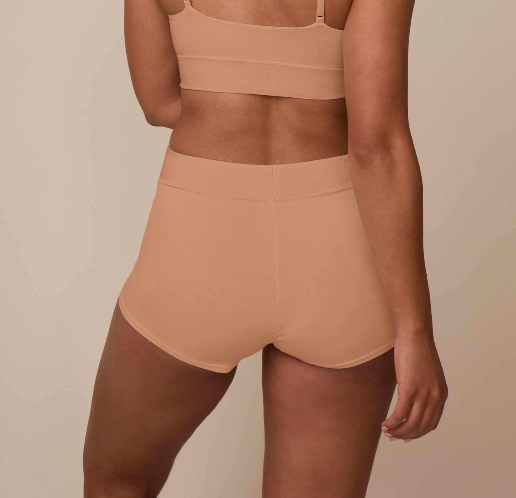 Back view of Nemesis in the Cloud Cotton High Waist Boyshort in Dune. The wide waistband and full rear coverage offer a smooth, secure fit without digging in.