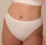 Close-up of the Cloud Cotton French Cut Brief in Quartz on model Sonnie. The image draws attention to the soft cotton fabric and minimal seaming around the waistband and leg openings.