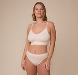 Full-body view of model Sonnie in the Cloud Cotton French Cut Brief and matching Cloud Cotton Triangle Bralette in Quartz. The image captures a clean, coordinated look ideal for lounging or everyday wear.