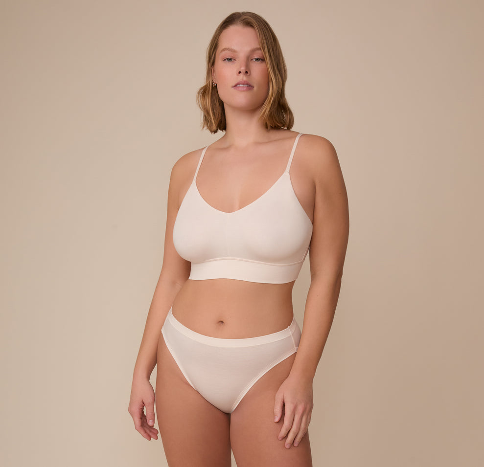 Full-body view of model Sonnie in the Cloud Cotton French Cut Brief and matching Cloud Cotton Triangle Bralette in Quartz. The image captures a clean, coordinated look ideal for lounging or everyday wear.