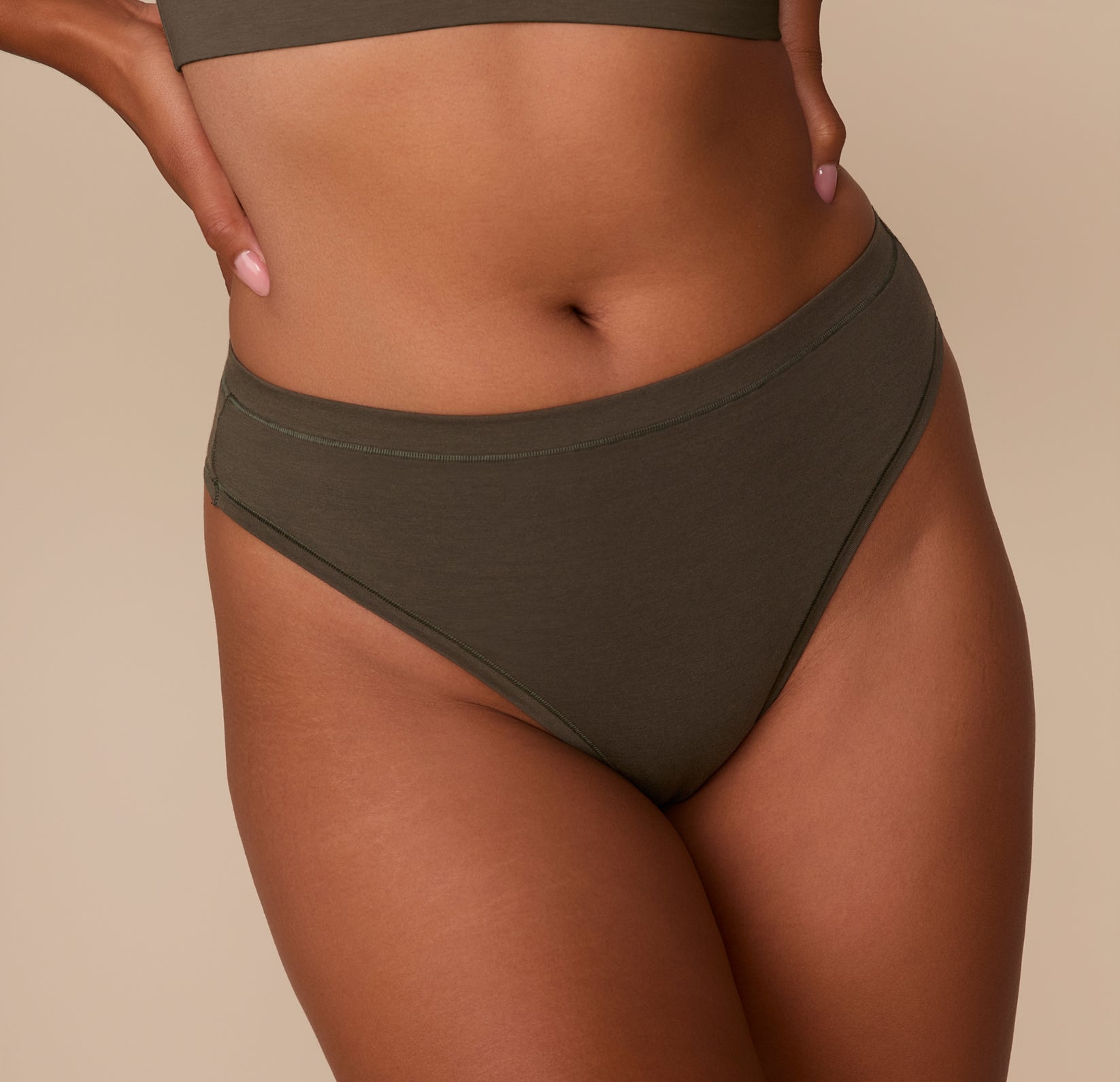 Close-up of Victoria in the Cloud Cotton Highwaist Thong in Olive, focusing on the high waistband and soft cotton-modal fabric.