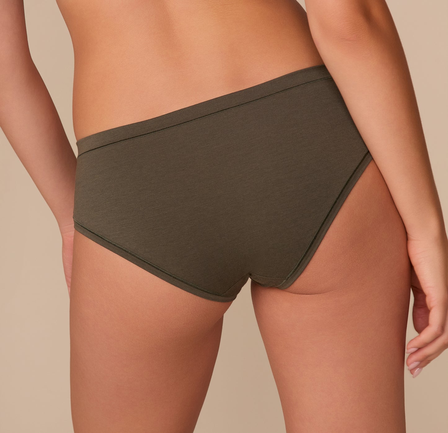 Close-up back angled view of Alexis in the Cloud Cotton Hiphugger in Olive, showcasing soft stretch cotton fabric.
