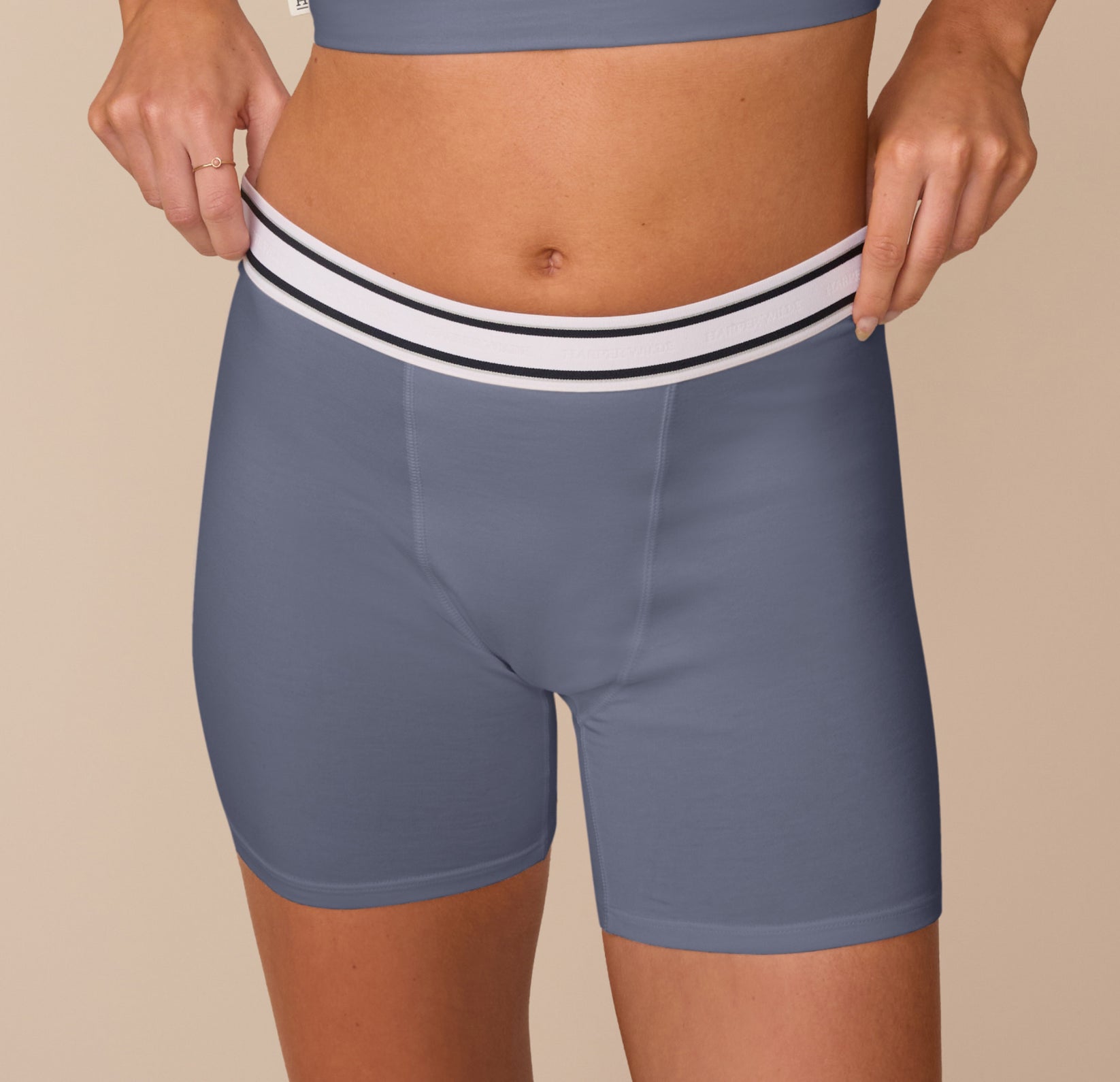 Close-up of Freya wearing the Cloud Cotton Boxer Brief in Slate, highlighting the retro-inspired striped waistband and smooth, form-fitting cotton modal blend.