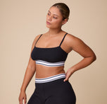 India wears the Cloud Cotton Retro Bandeau Bralette in Black, paired with the matching Cloud Cotton Boxer Brief. The bold black color contrasts with the white striped band for a modern, sporty aesthetic. sizing: India wears size Large
