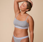 Three quarter angle of India in the Cloud Cotton Retro Bandeau Bralette in Heather Charcoal, highlighting the soft, stretch fabric and the supportive elastic underband.