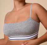 Close-up of India wearing the Cloud Cotton Retro Bandeau Bralette in Heather Charcoal, emphasizing the soft, breathable fabric and the contrast stripe elastic band.