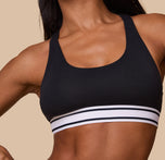 A detailed shot focusing on the soft, ribbed elastic underband. The comfortable cotton material and scoop neckline are emphasized.