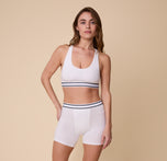 A full-length image of Gracie in the Cloud Cotton Retro Racerback Bralette, paired with matching Cloud Cotton Retro Boxer Brief in White.