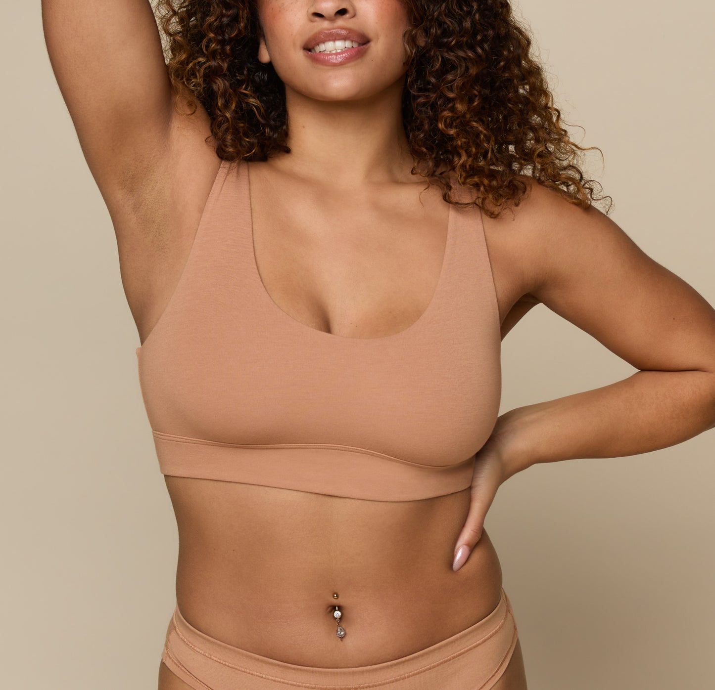 Jade wearing the Cloud Cotton Scoop in Dune. The scoop neckline and ultra-soft cotton modal fabric are emphasized. sizing: Jade wears size Medium