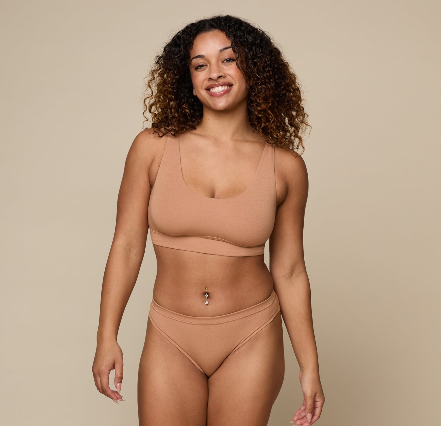 Full body shot of Jade wearing the Cloud Cotton Scoop and Cloud Cotton Bikini in Dune. The scoop neckline and ultra-soft cotton modal fabric are emphasized.