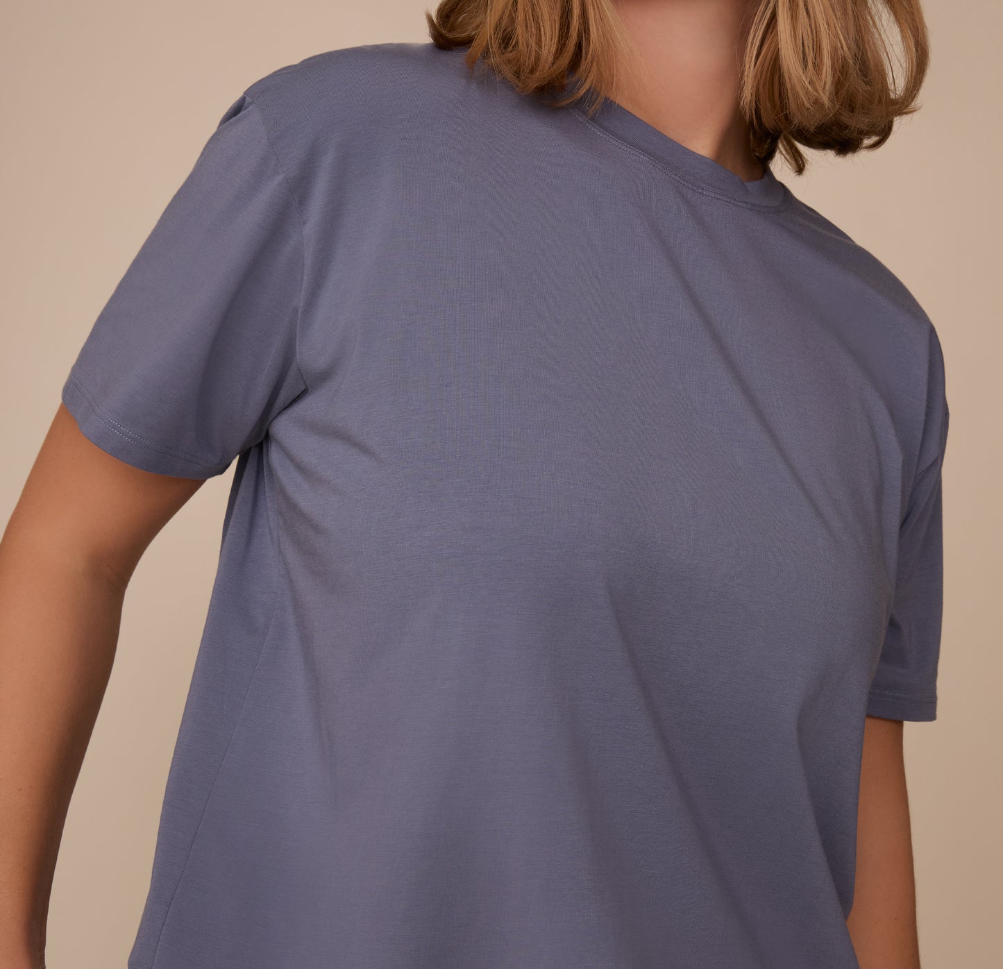 Close-up of the upper half of Sonnie wearing the Cloud Cotton T-Shirt in Slate. The image captures the softness of the cotton-modal fabric.