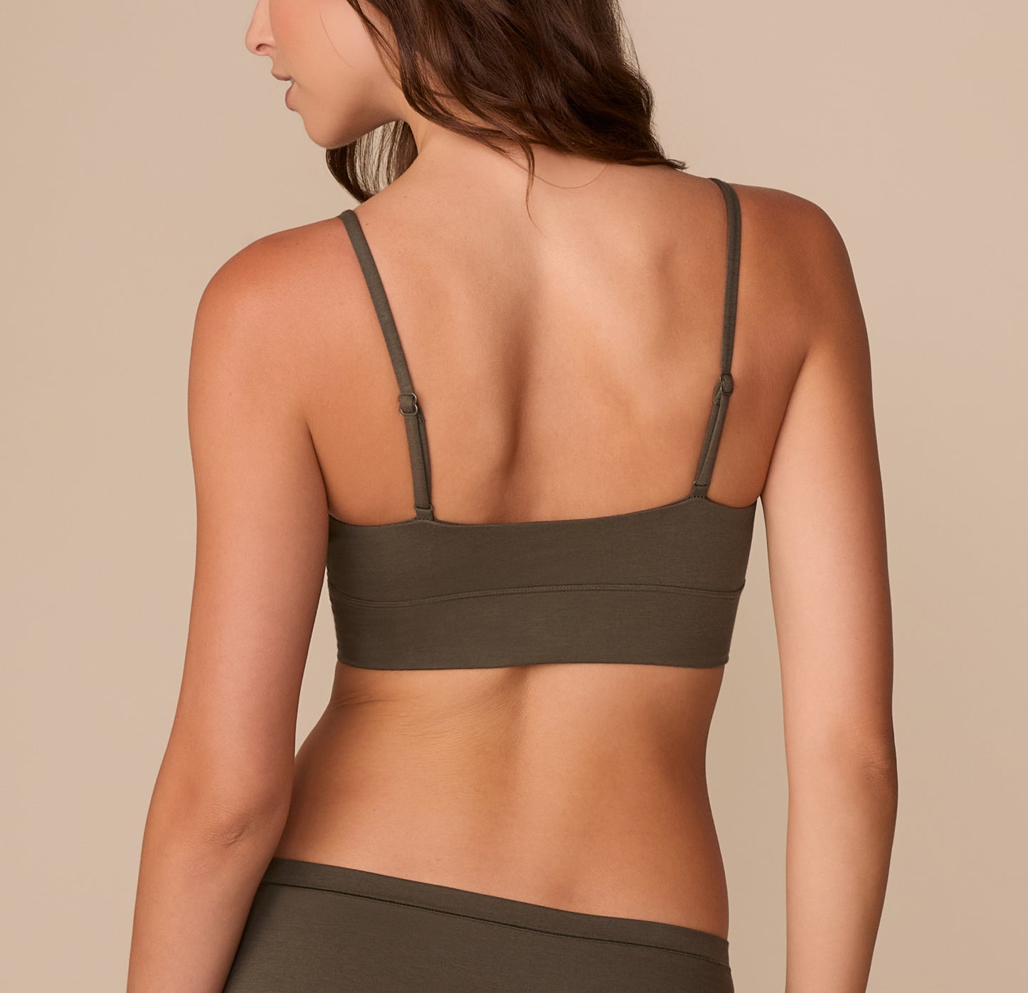 Back view of Alexis in the Cloud Cotton Thin Strap Bralette in Olive, highlighting the smooth band and thin straps.