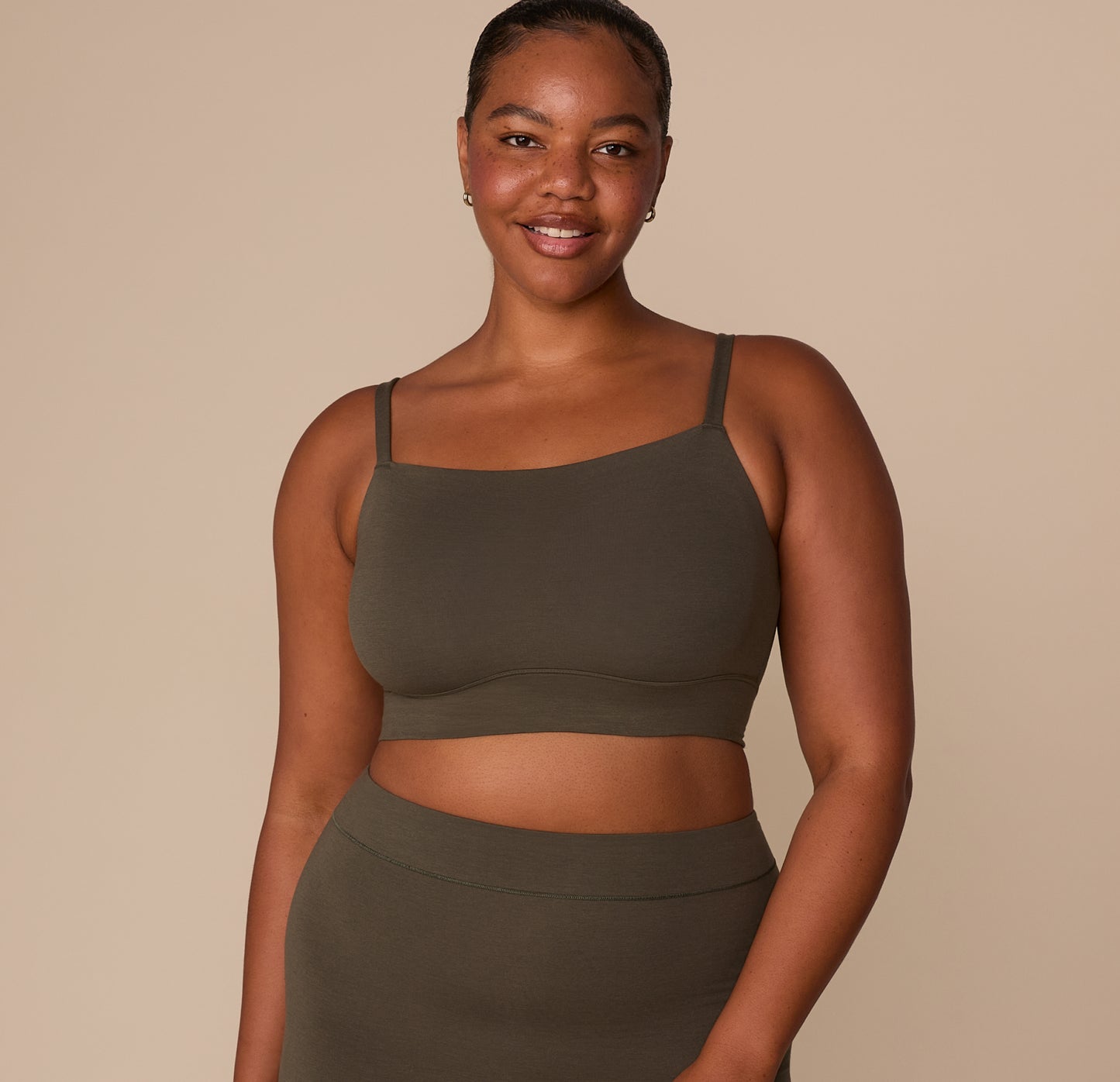 Zarria wearing the Cloud Cotton Thin Strap Bralette in Olive, smiling while paired with the matching Cloud Cotton Highwaist Boyshort. sizing: Zarria wears size XL