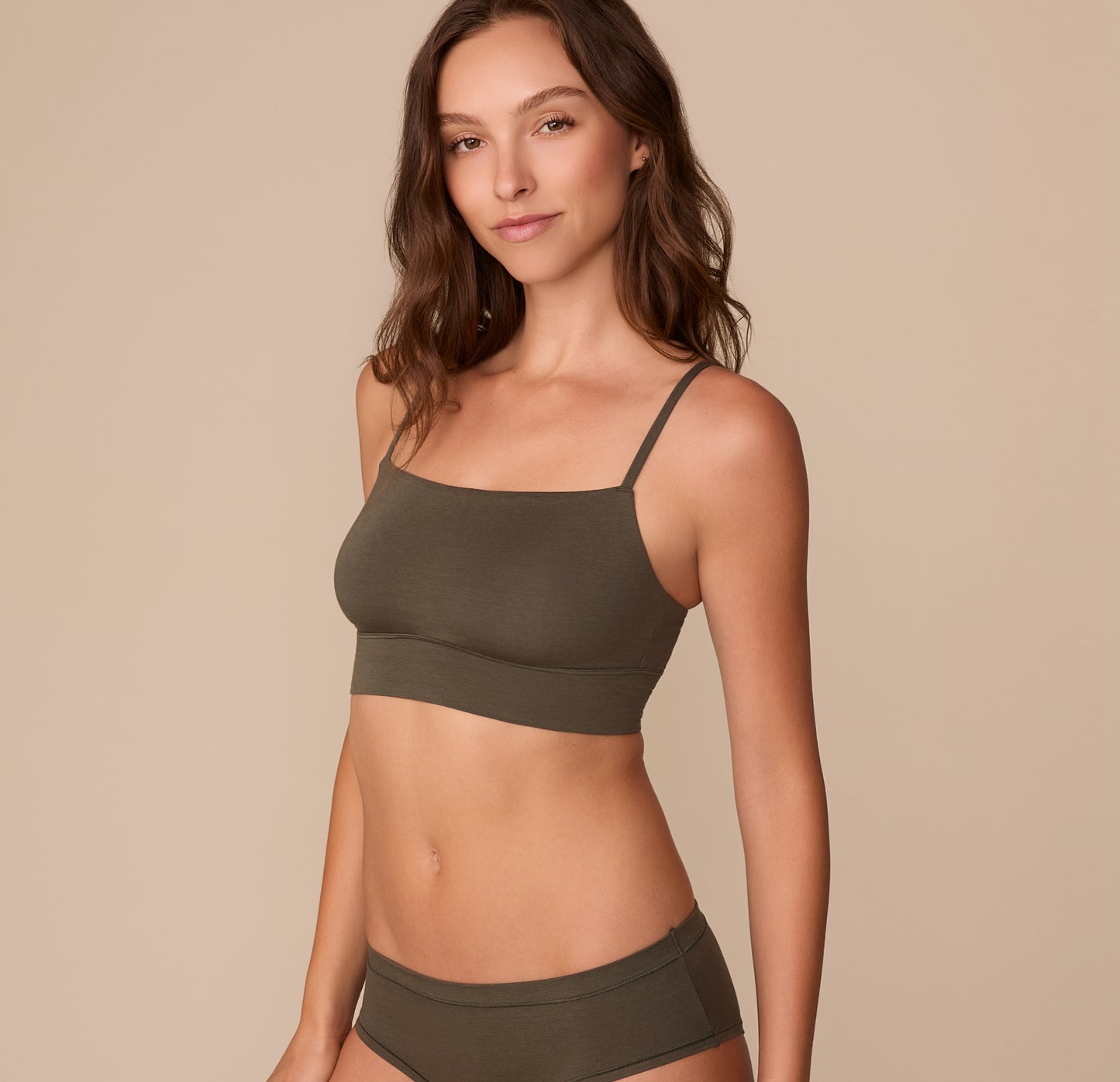 Alexis in the Cloud Cotton Thin Strap Bralette in Olive with the matching Cloud Cotton Hiphugger shown from the side to highlight the square neckline.