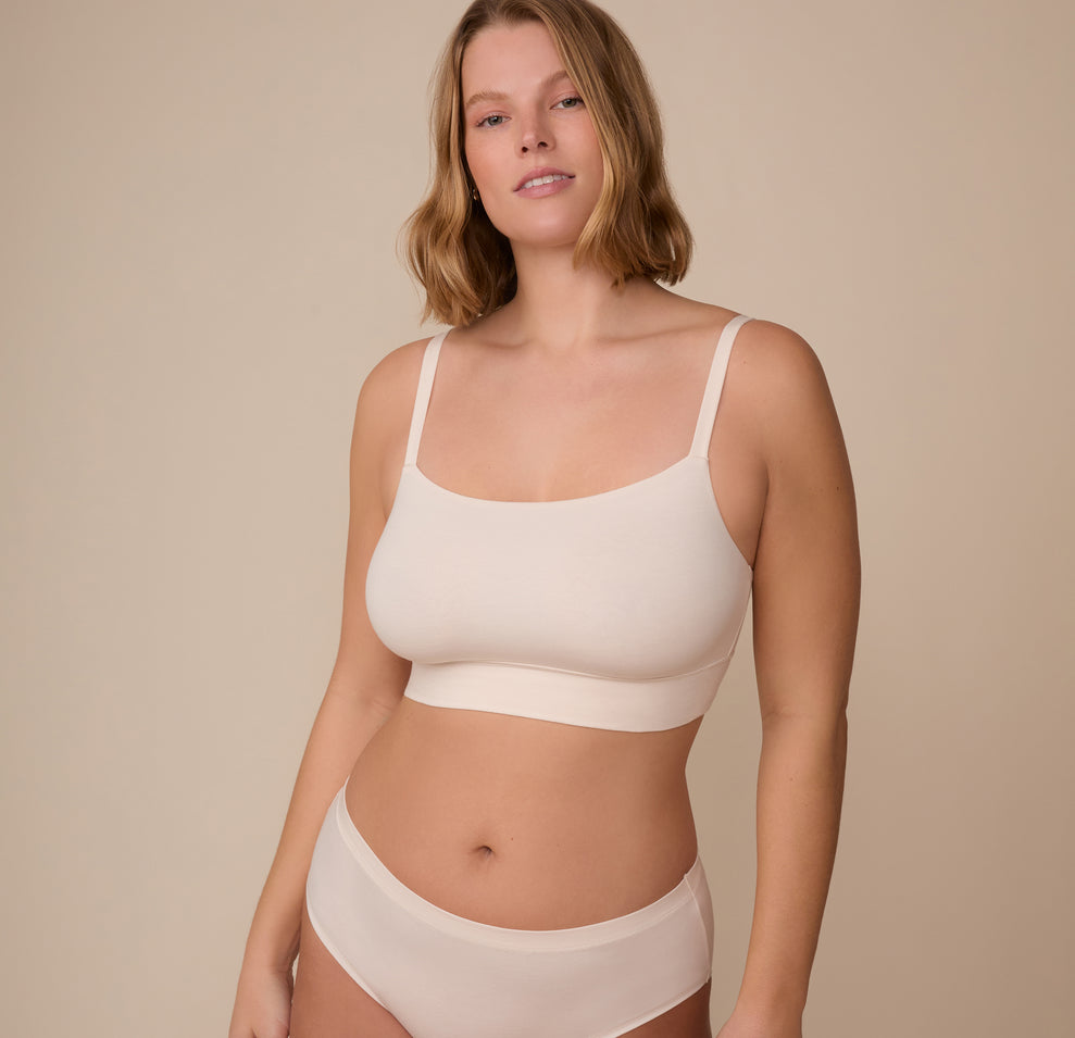 Front view of model Sonnie wearing the Cloud Cotton Thin Strap Bralette in Quartz. The image features the scoop neckline and cloud-like fabric that offers comfort without compression. sizing: Sonnie wears size Large