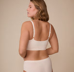 Back view of model Sonnie in the Cloud Cotton Thin Strap Bralette in Quartz. This angle showcases the smooth back panel and how the bralette hugs the body with ease and comfortability.