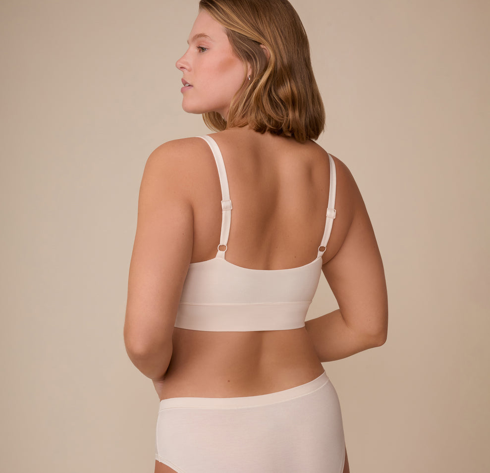 Back view of model Sonnie in the Cloud Cotton Thin Strap Bralette in Quartz. This angle showcases the smooth back panel and how the bralette hugs the body with ease and comfortability.