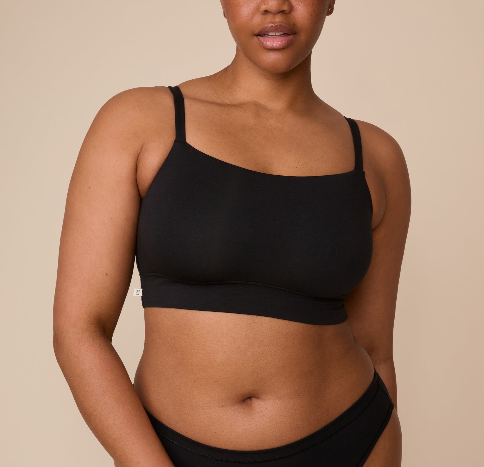 Zarria wears the Cloud Cotton Thin Strap Bralette in Black. The bralette features a sleek, slightly curved neckline and thin adjustable straps, offering a smooth and supportive fit across the chest. sizing: Zarria wears size XL