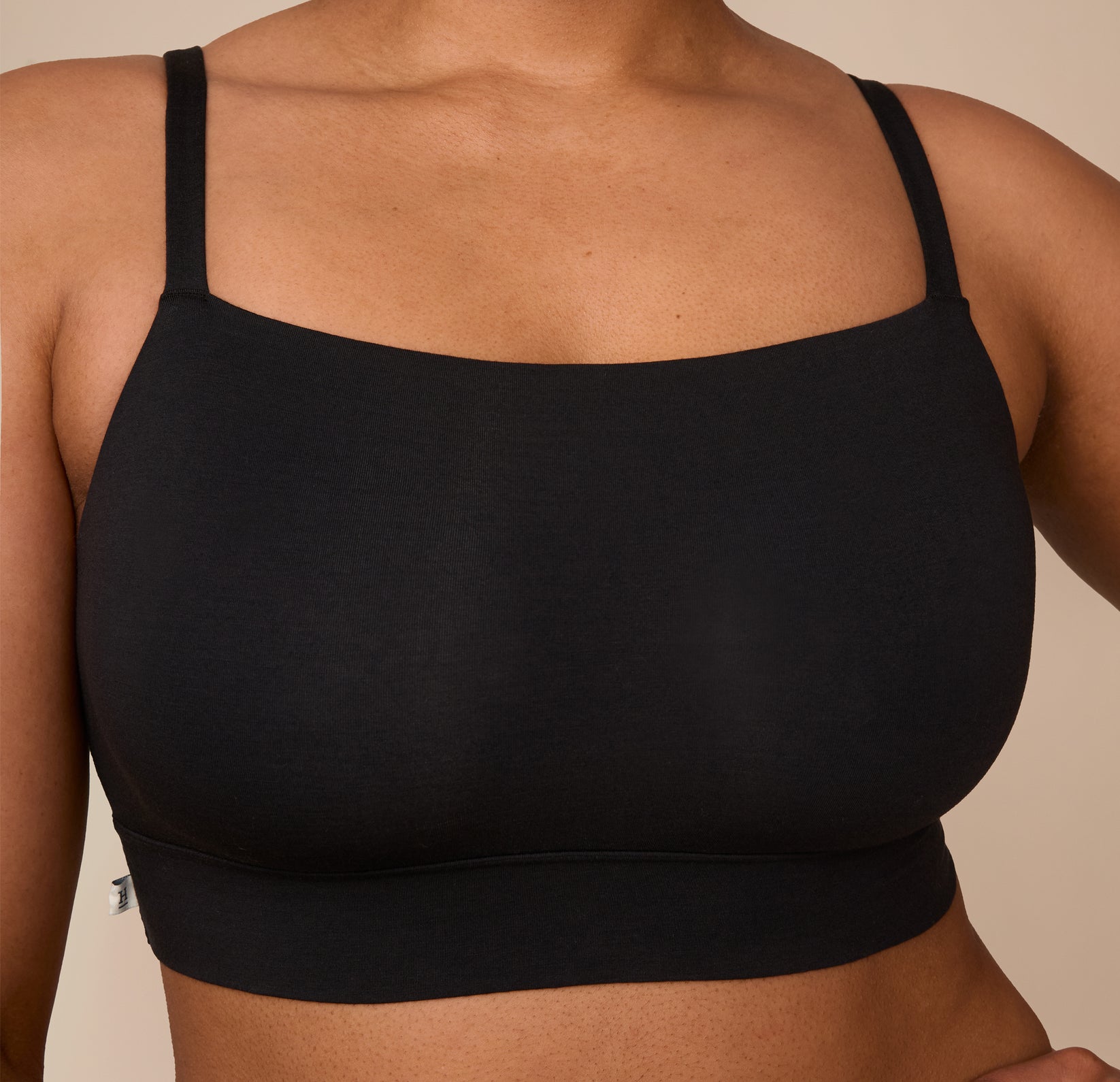 Close-up of Zarria in the Cloud Cotton Thin Strap Bralette in Black, focusing on the smooth fabric and flattering neckline.