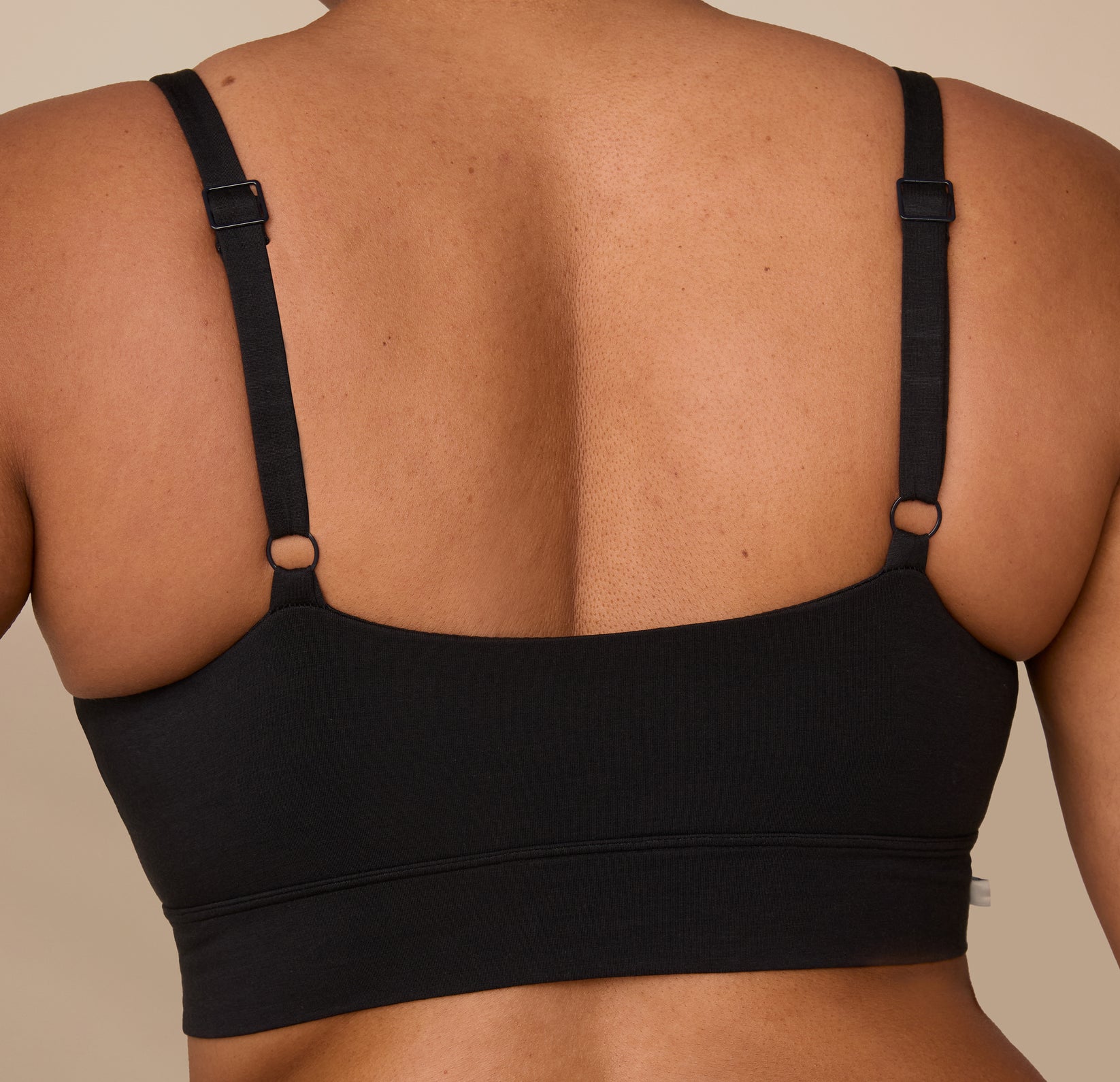 Detailed close-up of the back of the Cloud Cotton Thin Strap Bralette worn by Zarria, showing the minimal seam band and thin strap adjusters.
