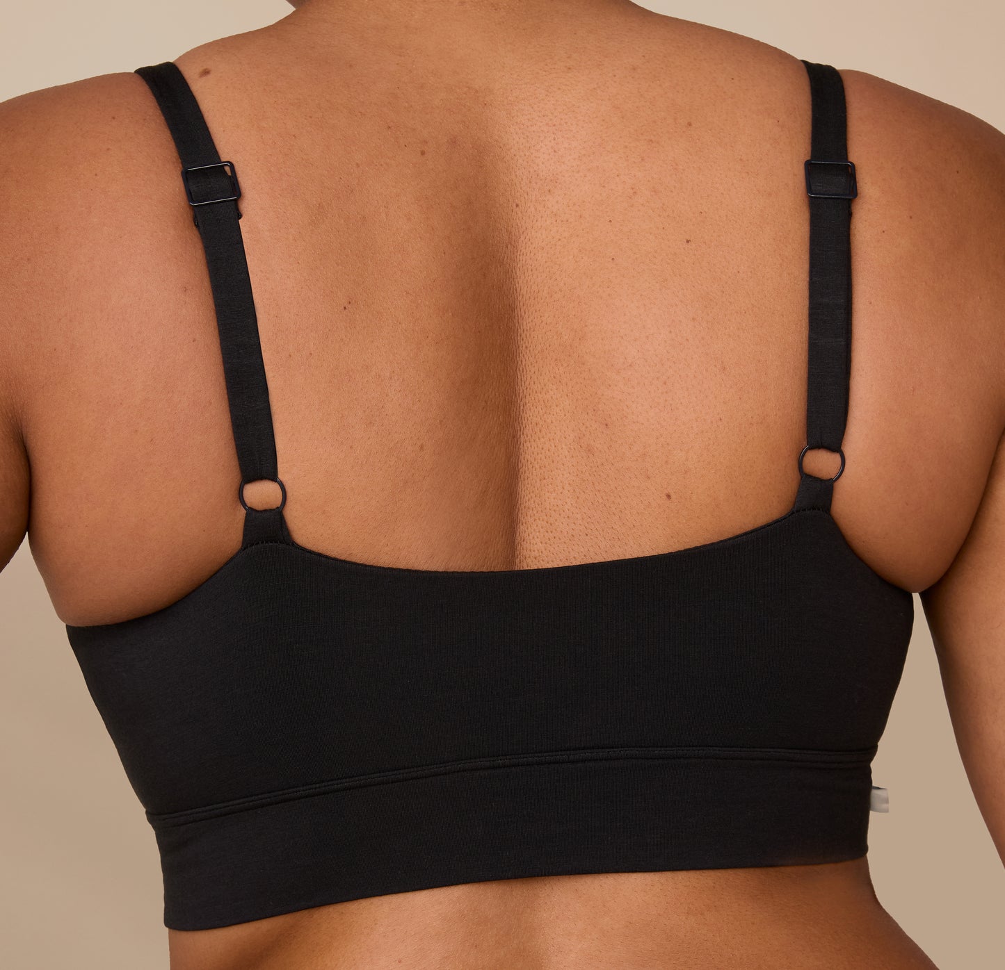 Detailed close-up of the back of the Cloud Cotton Thin Strap Bralette worn by Zarria, showing the minimal seam band and thin strap adjusters.