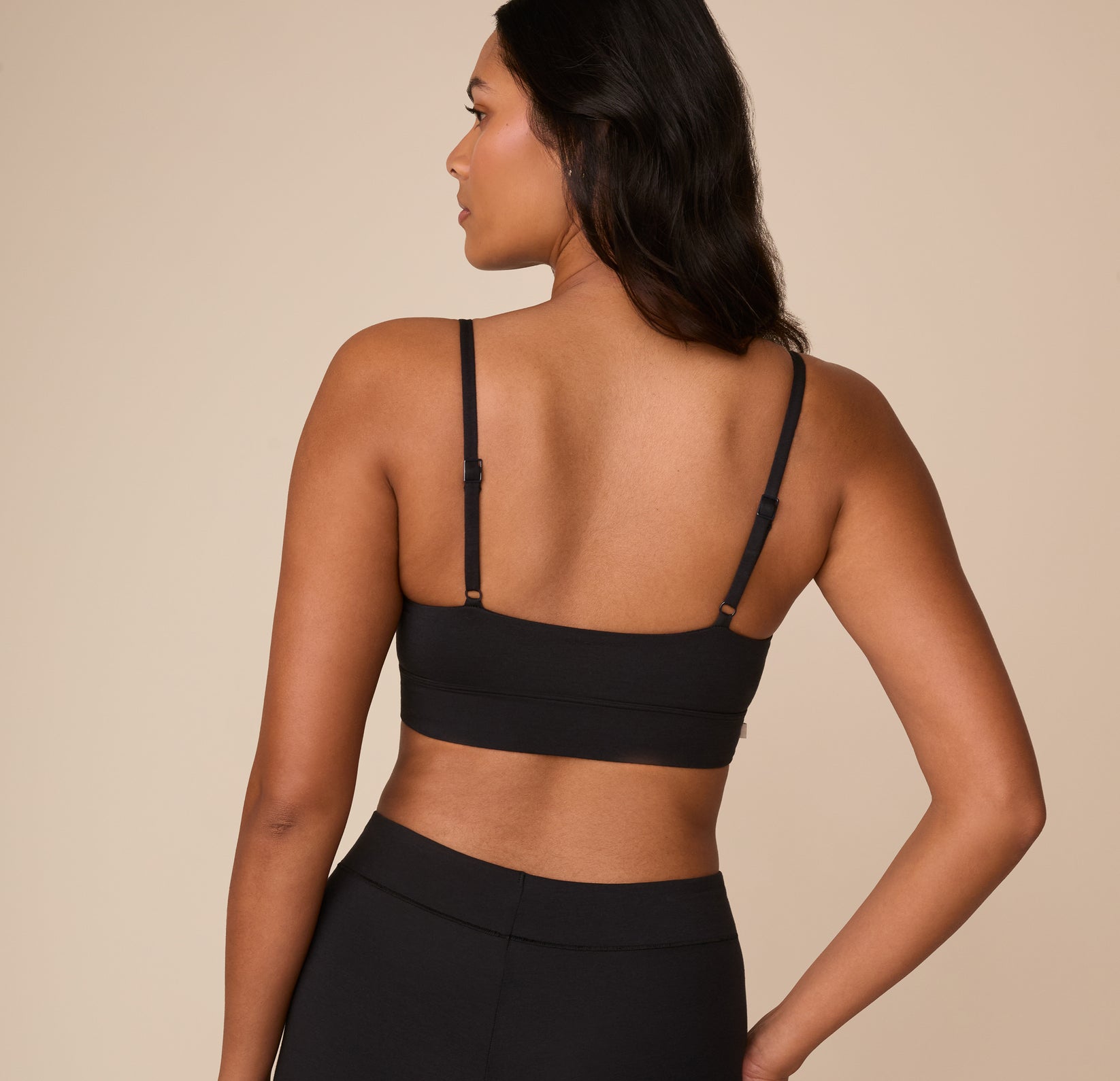 Back view of Victoria in the Cloud Cotton Thin Strap Bralette in Black, emphasizing the smooth finish and adjustable support.