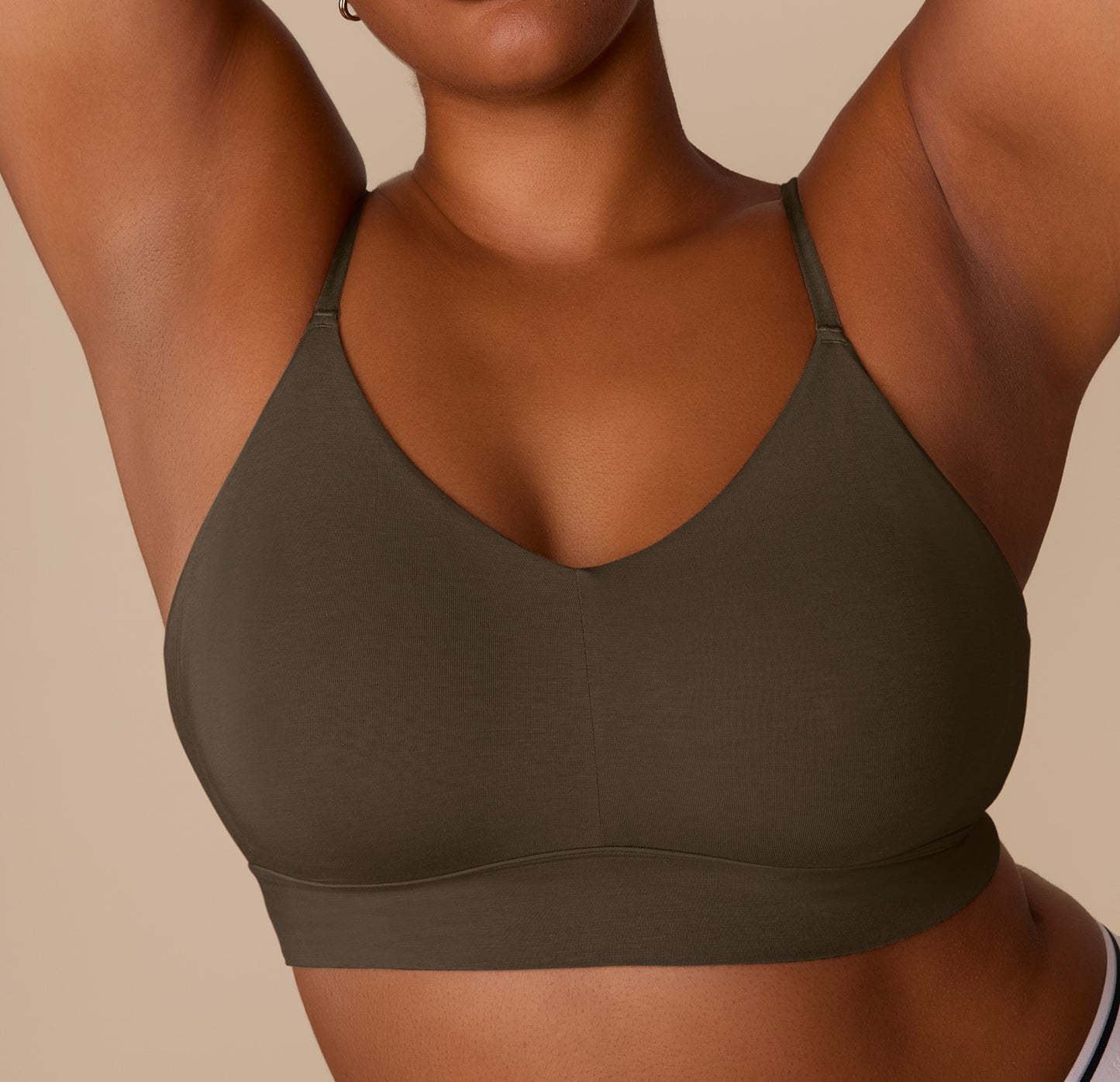 Close-up of Zarria in the Cloud Cotton Triangle Bralette in Olive, highlighting the deep V neckline and longline band.
