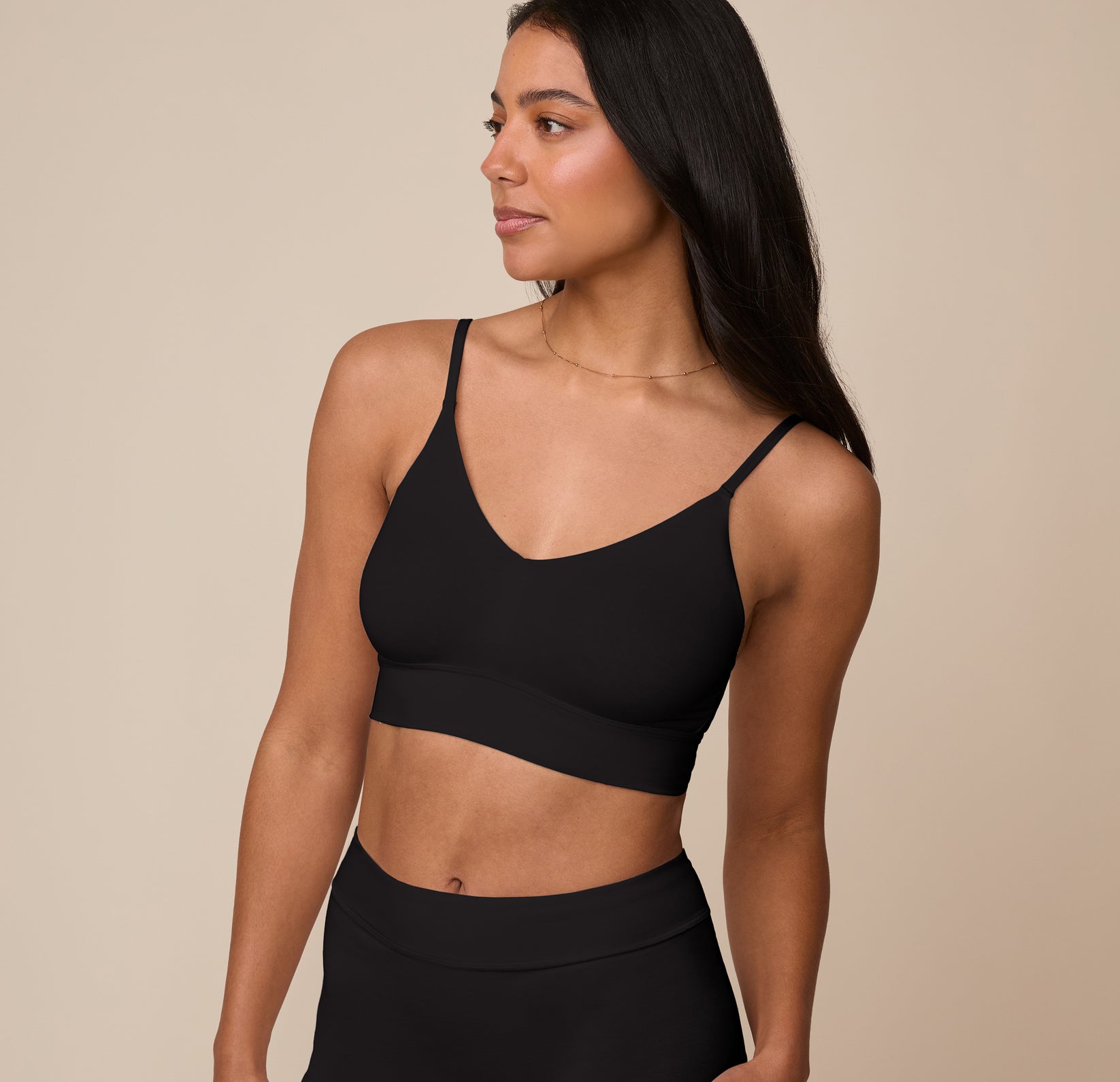 Three quarter view of Nemesis in the Cloud Cotton Triangle Bralette in Black. The image highlights the bralette’s sleek fit, soft shaping, and smooth stretch cotton fabric.