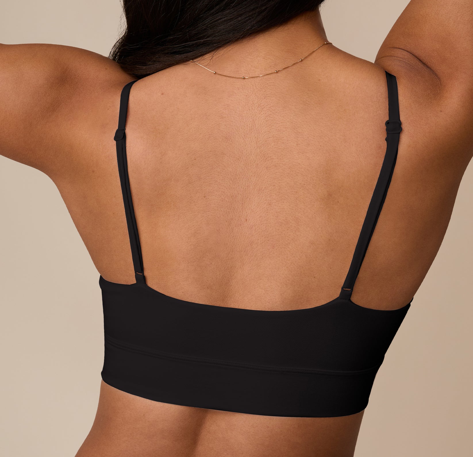 Rear close-up of Nemesis in the Cloud Cotton Triangle Bralette in Black. The scoop-back cut and adjustable straps are designed for all-day comfort and customizable fit.