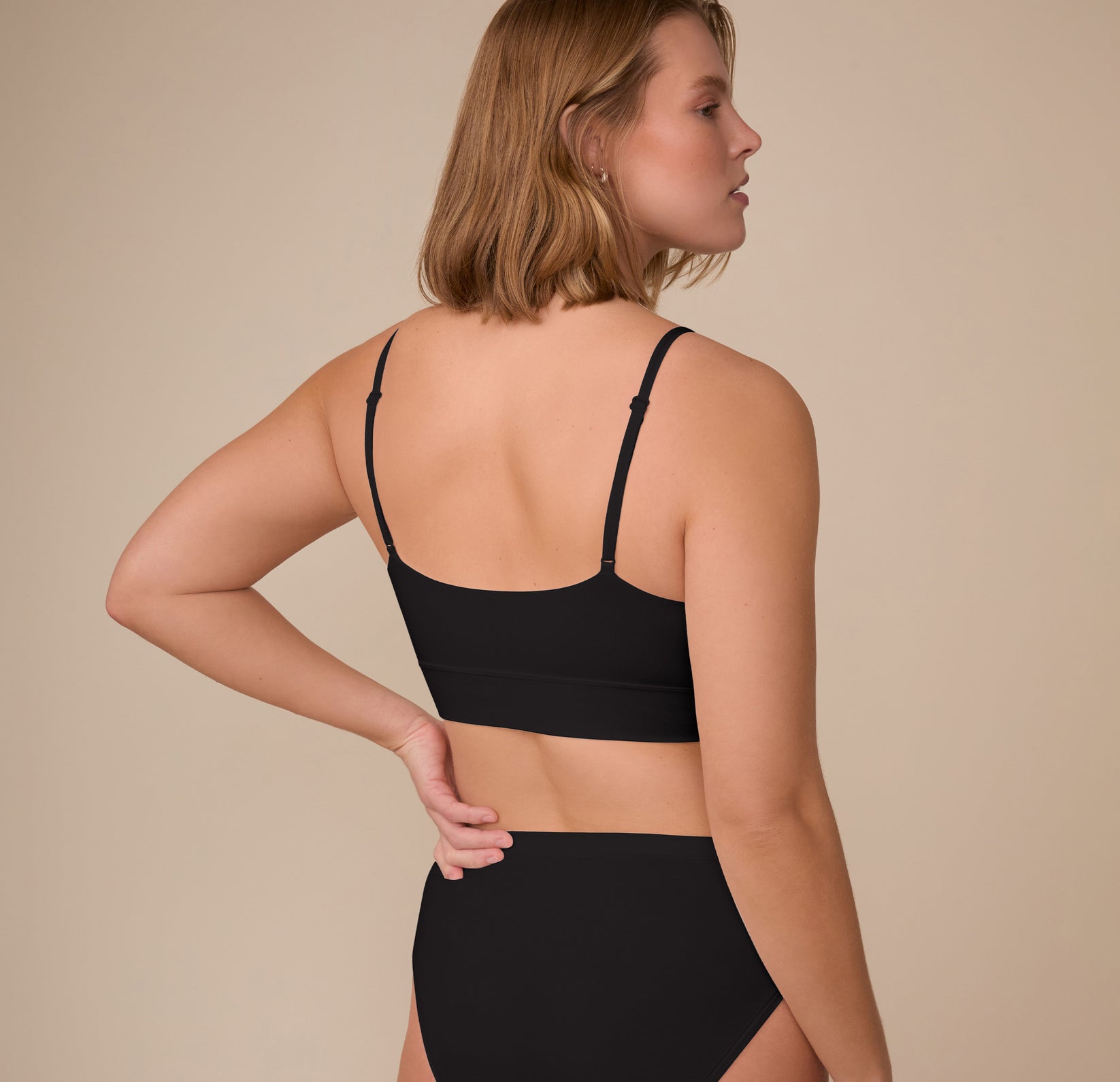 Back view of Sonnie in the Cloud Cotton Triangle Bralette in Black. The stretch cotton blend and smooth construction offer a no-dig, barely-there feel.