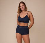 Full body view of Sonnie wearing the Cloud Cotton Triangle Bralette and Cloud Cotton Highwaist Boyshort in Midnight. The comfortable cotton-modal fabric of the matching set is emphasized.