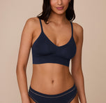 Marcela wearing the Cloud Cotton Triangle Bralette and Cloud Cotton Highwaist Thong in Midnight. The low v-neck neckline and thin straps are emphasized. sizing: Marcela wears size Small